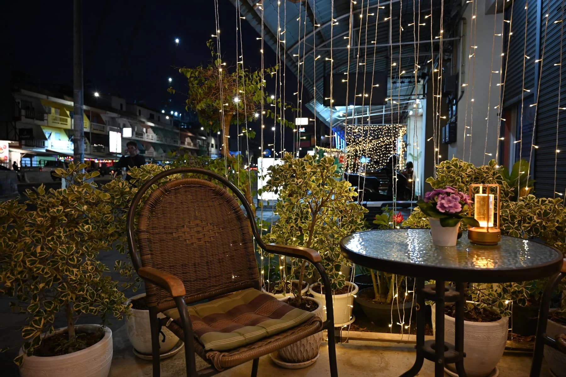 A terrace at dusk, chairs pulled around a table